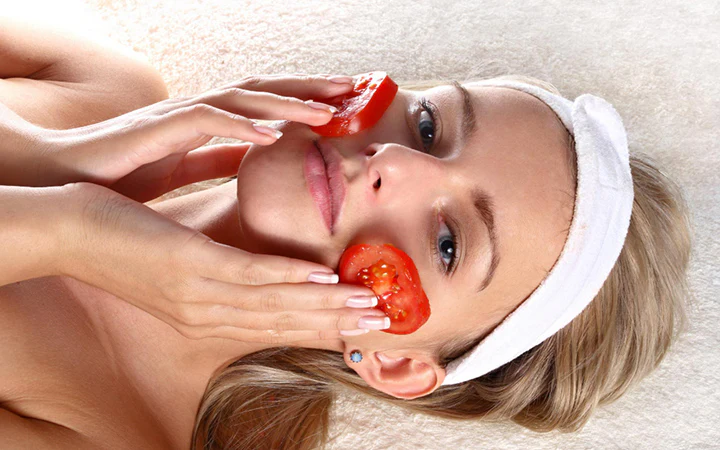 Tomato slice rubbing on face	