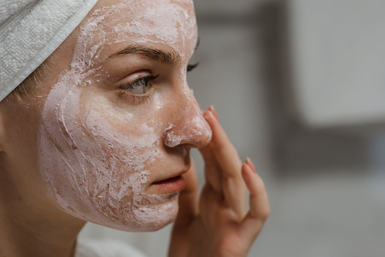 Woman applying honey & lemon face pack	